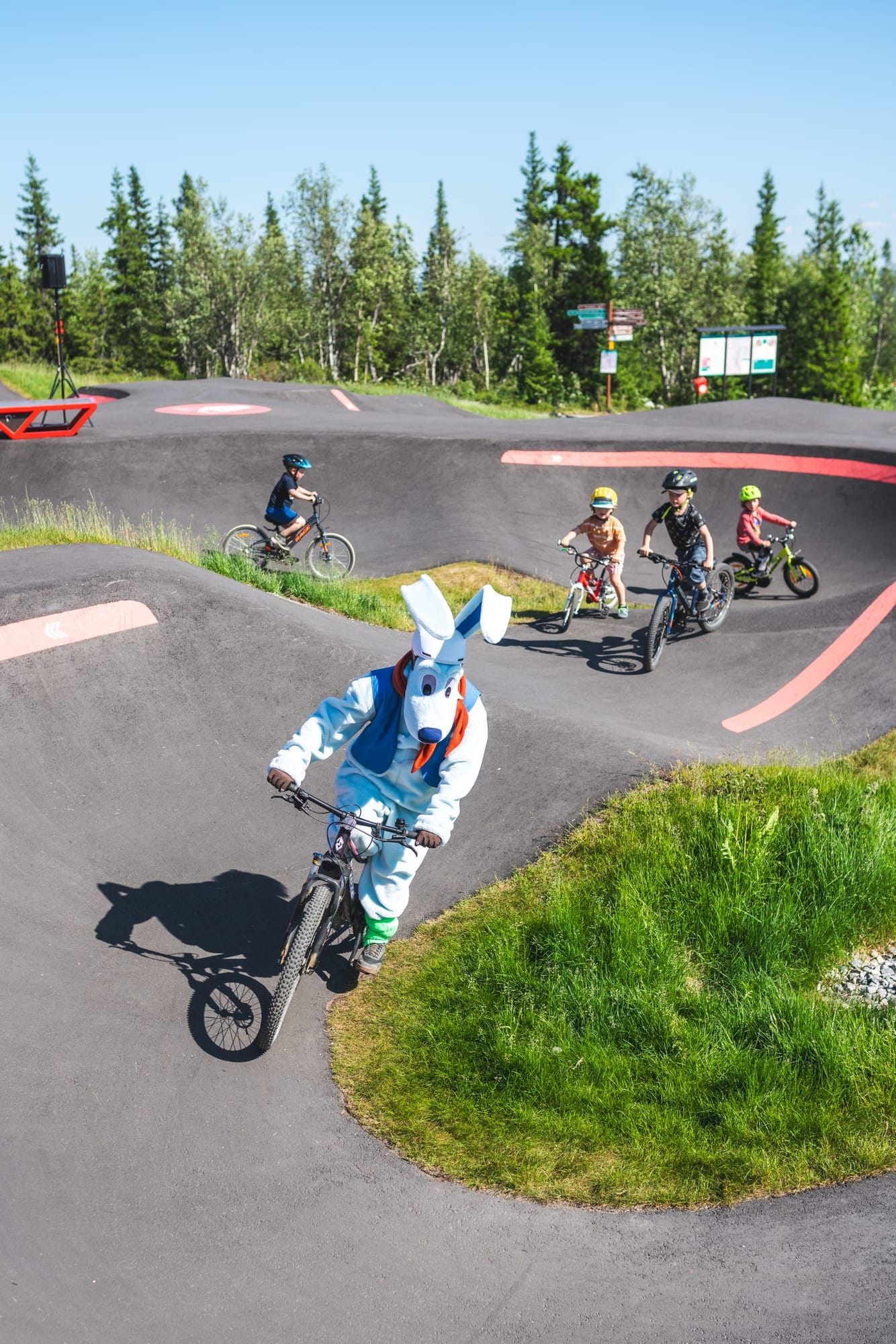 Rider of all ages enjoying the Ylläs Bike Park pump track